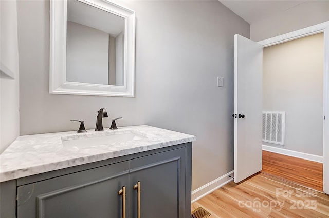 bathroom with vanity and wood-type flooring