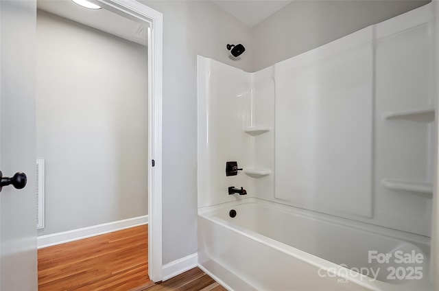 bathroom with wood-type flooring and shower / bath combination