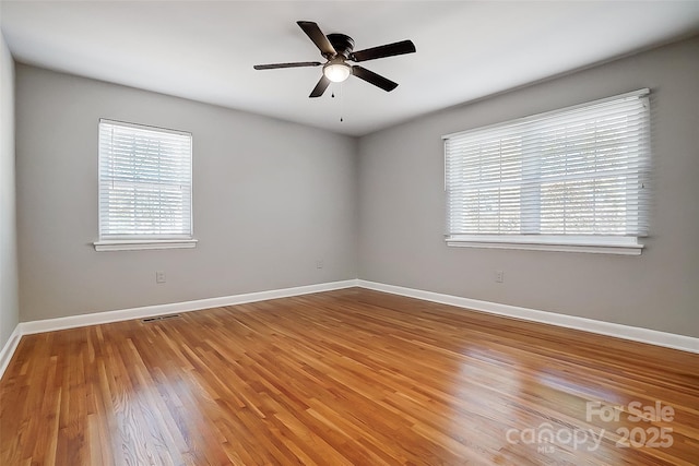 unfurnished room with hardwood / wood-style flooring and ceiling fan