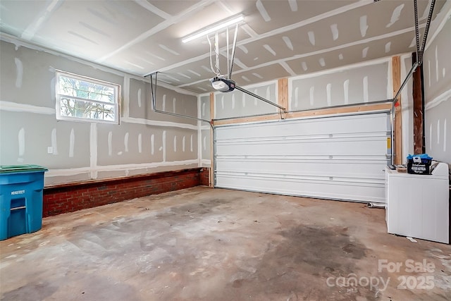 garage featuring washer / clothes dryer and a garage door opener