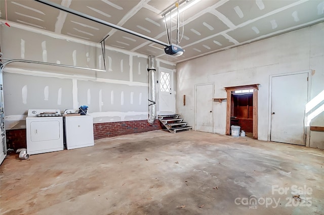 garage featuring separate washer and dryer and a garage door opener