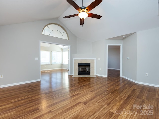 unfurnished living room with ceiling fan, dark wood-type flooring, and high vaulted ceiling