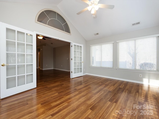 empty room featuring ceiling fan, dark wood-type flooring, high vaulted ceiling, and french doors