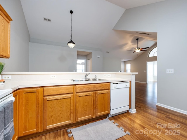 kitchen featuring ceiling fan, sink, dishwasher, pendant lighting, and range