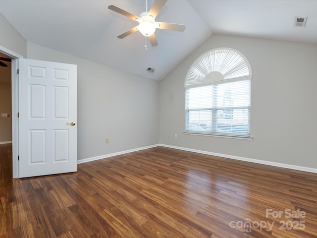 spare room featuring dark hardwood / wood-style floors, ceiling fan, and lofted ceiling