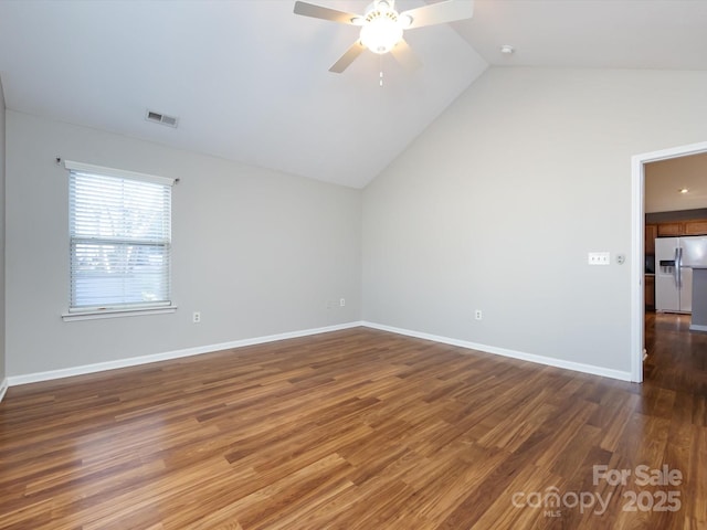 empty room featuring ceiling fan, dark hardwood / wood-style flooring, and lofted ceiling