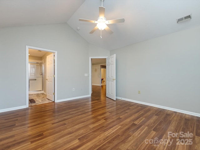 unfurnished bedroom featuring ensuite bath, ceiling fan, dark hardwood / wood-style flooring, and high vaulted ceiling