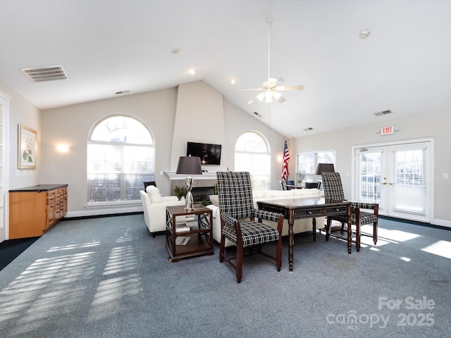 dining room featuring dark colored carpet, french doors, vaulted ceiling, and ceiling fan