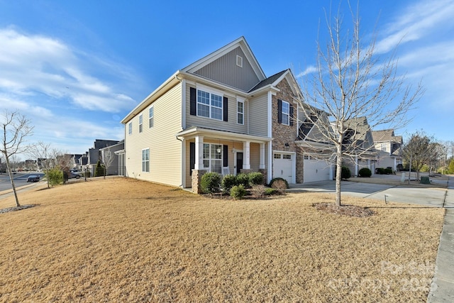 view of front of home featuring a garage, a porch, and a front yard