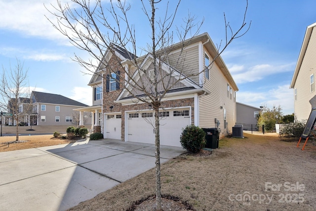 view of side of property with central AC and a garage