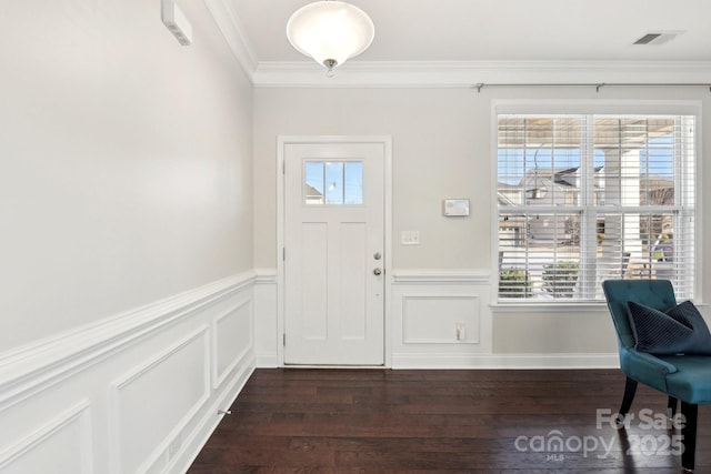 entryway with dark hardwood / wood-style flooring, a wealth of natural light, and ornamental molding