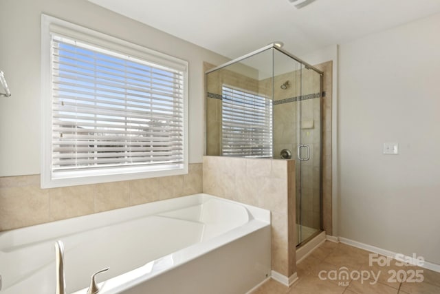 bathroom with separate shower and tub and tile patterned flooring