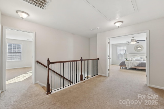 hall featuring light colored carpet