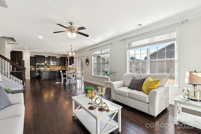 living room with ceiling fan, ornamental molding, and dark hardwood / wood-style flooring