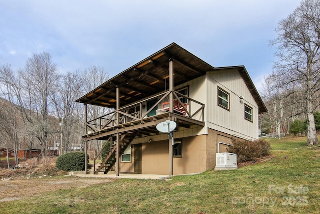 rear view of property with a lawn and a deck