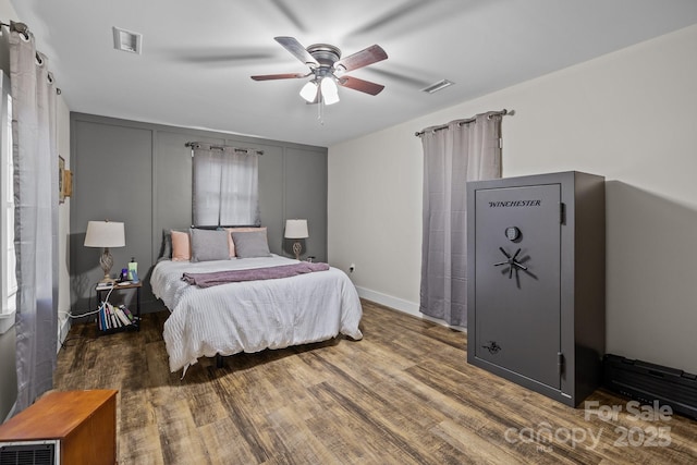 bedroom featuring ceiling fan and dark hardwood / wood-style flooring