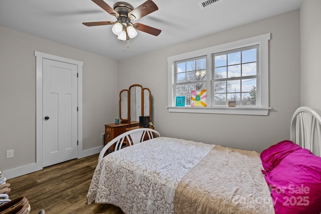 bedroom with ceiling fan and dark hardwood / wood-style flooring