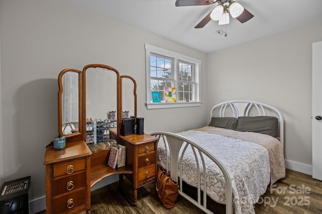 bedroom with ceiling fan and dark wood-type flooring