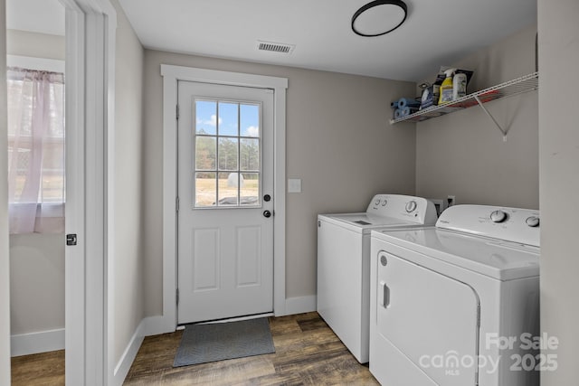 washroom featuring washer and dryer and dark wood-type flooring