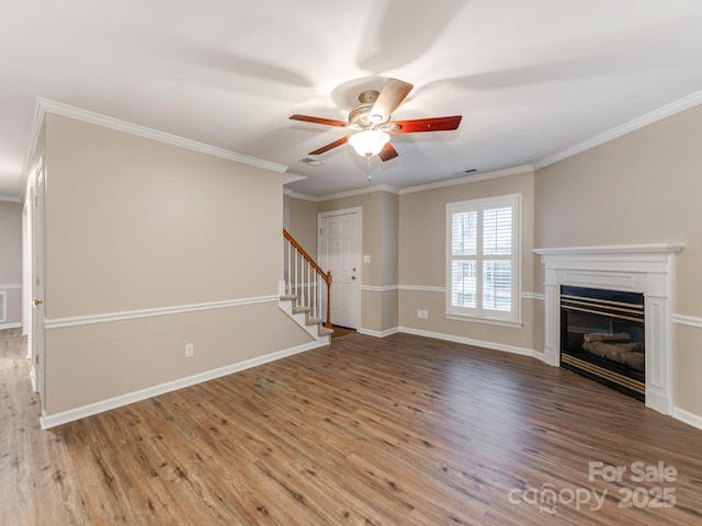 unfurnished living room featuring hardwood / wood-style floors, ceiling fan, and ornamental molding