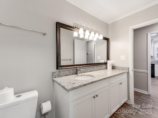 bathroom with hardwood / wood-style floors, vanity, toilet, and crown molding