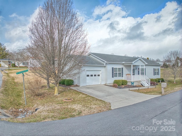 single story home featuring a front yard, a porch, and a garage