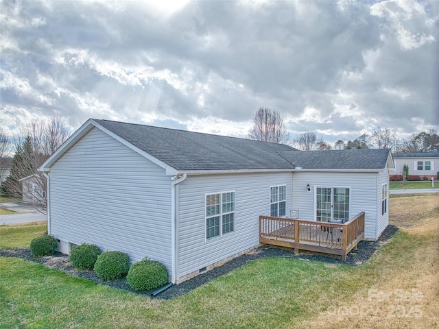 rear view of property with a deck and a lawn