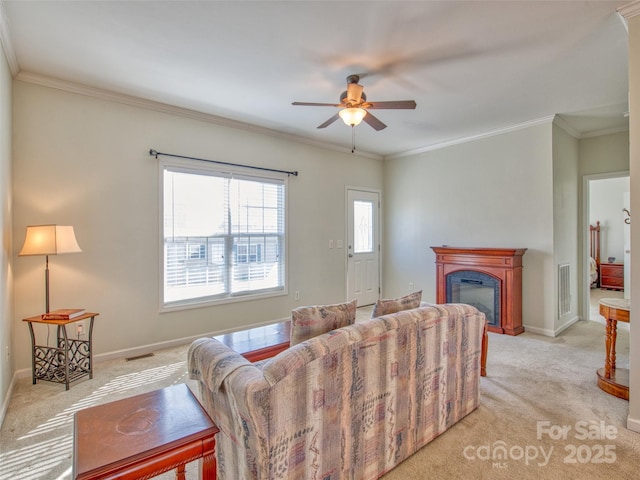 living room with light colored carpet, ceiling fan, and crown molding