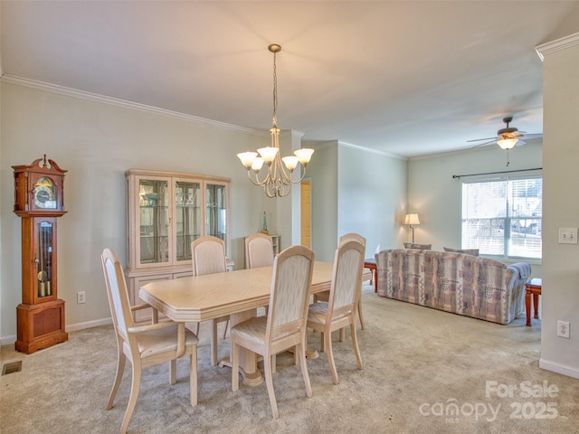 carpeted dining space with crown molding and ceiling fan with notable chandelier