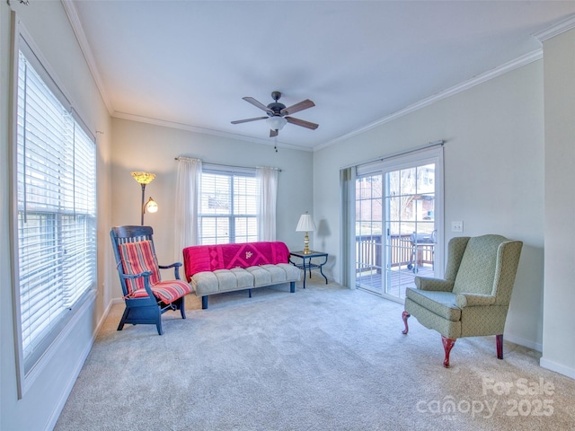 living area featuring carpet flooring, ornamental molding, and a wealth of natural light