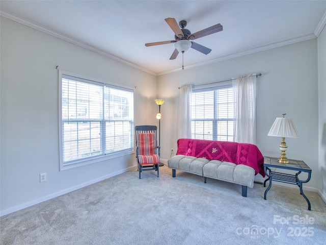 sitting room with carpet flooring, crown molding, and ceiling fan