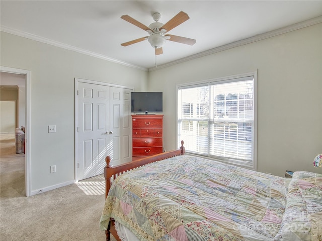 bedroom with carpet flooring, a closet, ceiling fan, and ornamental molding