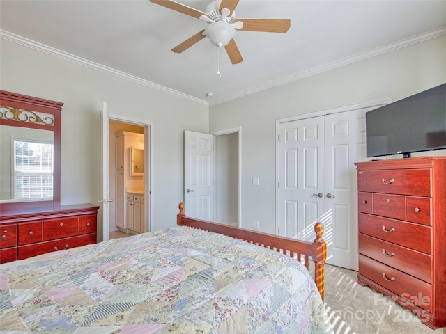 bedroom featuring ensuite bath, ceiling fan, a closet, and ornamental molding