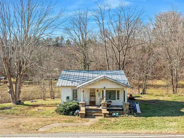 bungalow-style house with a front lawn and a porch