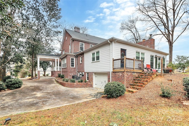 view of home's exterior featuring a garage and central air condition unit