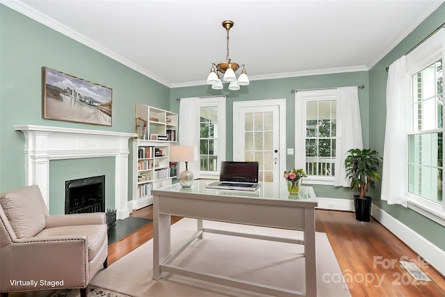 office space featuring crown molding, hardwood / wood-style floors, and an inviting chandelier