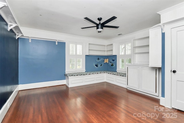 interior space featuring ceiling fan, dark hardwood / wood-style floors, and ornamental molding