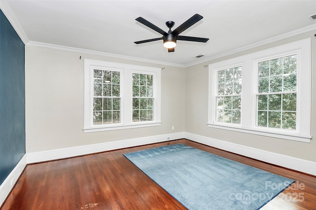 empty room with crown molding, dark hardwood / wood-style flooring, and ceiling fan