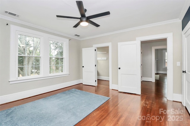 bedroom featuring ceiling fan, dark hardwood / wood-style flooring, and crown molding