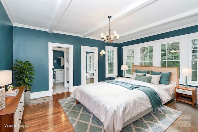 bedroom with beam ceiling, connected bathroom, a chandelier, hardwood / wood-style flooring, and ornamental molding