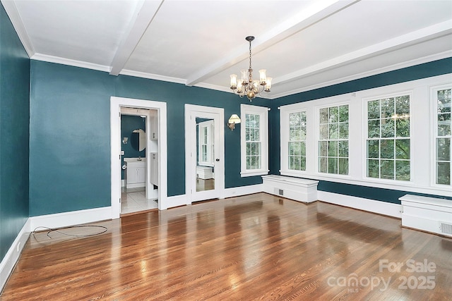 spare room with hardwood / wood-style flooring, crown molding, beamed ceiling, and a notable chandelier