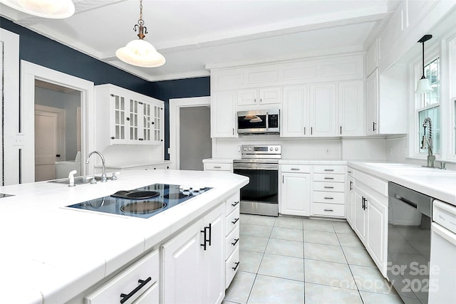 kitchen with sink, white cabinetry, stainless steel appliances, and hanging light fixtures