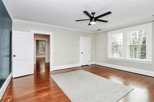 unfurnished room with crown molding, ceiling fan, and dark hardwood / wood-style floors