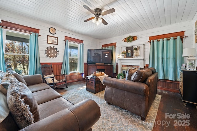 living room with a brick fireplace, ceiling fan, wooden walls, hardwood / wood-style flooring, and wooden ceiling