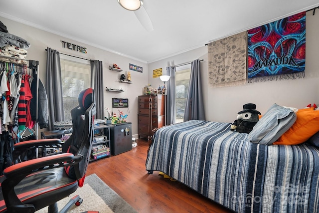 bedroom with ornamental molding and dark wood-type flooring