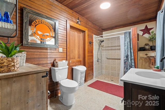 bathroom with wood ceiling, vanity, toilet, curtained shower, and wood walls