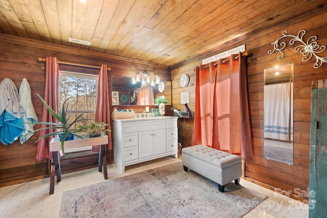 bathroom featuring wood walls, vanity, and wooden ceiling