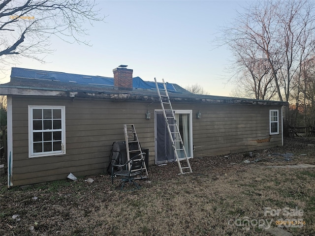 view of back house at dusk