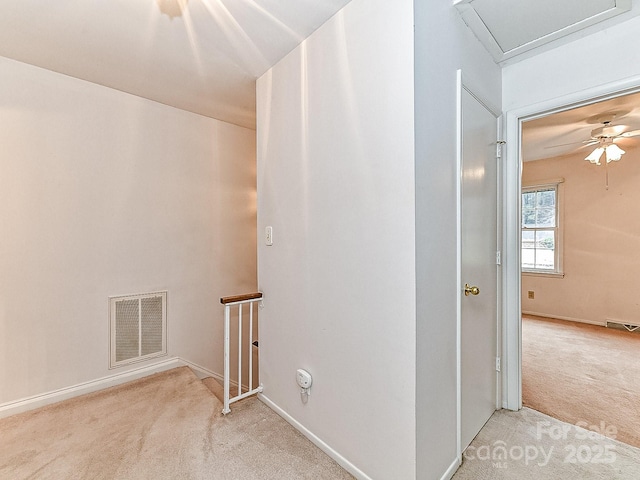 hall with light colored carpet