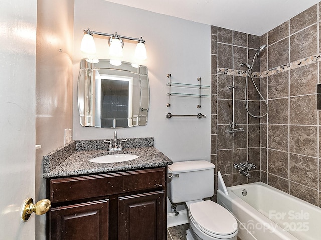 full bathroom with vanity, toilet, and tiled shower / bath